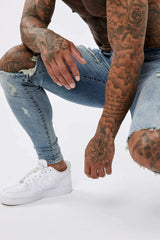SKINNY FIT JEANS RIPPED & REPAIRED - STRONG WASHED MID BLUE